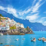 Beautiful Amalfi on hills leading down to coast, comfortable beaches and azure sea on Amalfi Coast in Campania, Italy