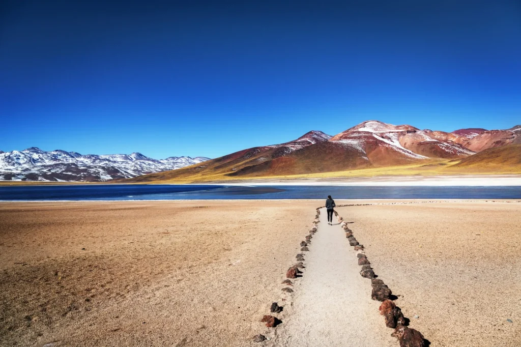 Tourist enjoying the beautiful landscape of Atacama Desert in Chile. Winter time.