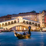 Romantic gondola ride near Rialto Bridge in Venice, Italy