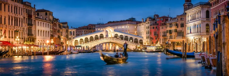 Romantic gondola ride near Rialto Bridge in Venice, Italy
