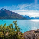 Panoramic view of the huge Perito Moreno glacier in Patagonia in golden Autumn, South America, sunny day, blue sky